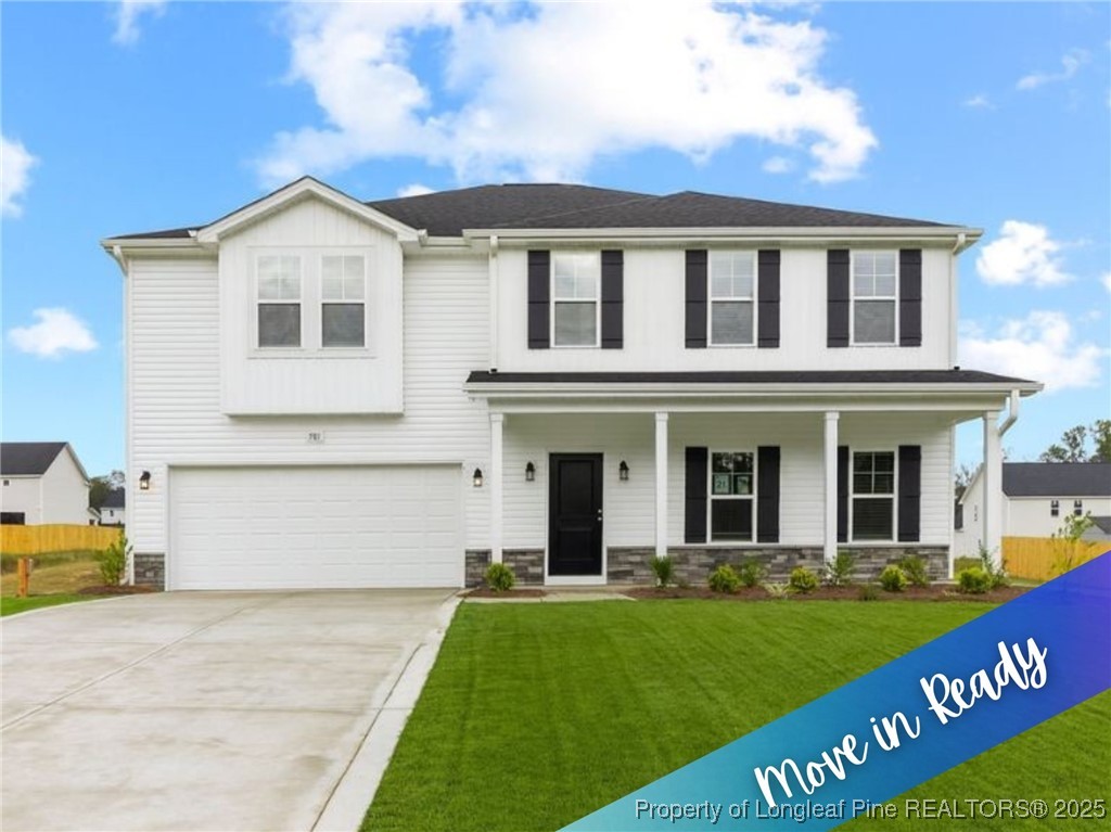 501 Traveller Way Raeford, NC 28376 - Photo 1 of 49 a front view of a house with a yard and garage