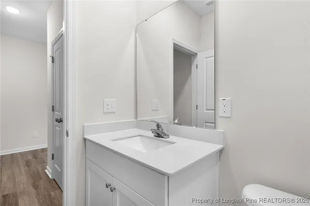 a bathroom with a sink toilet and a mirror