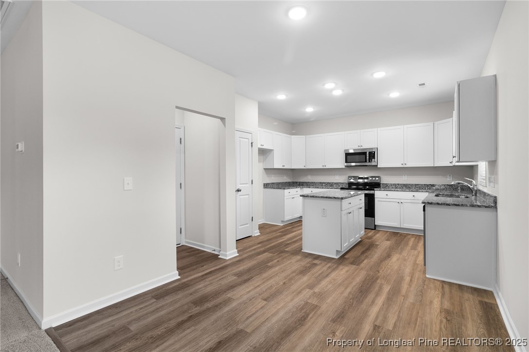 501 Traveller Way Raeford, NC 28376 - Photo 16 of 49 a kitchen with a refrigerator and white cabinets