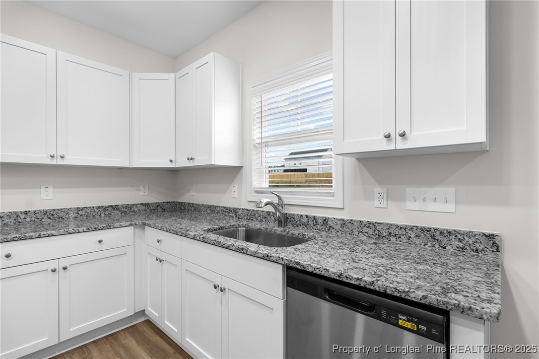 501 Traveller Way Raeford, NC 28376 - Photo 19 of 49 a kitchen with granite countertop white cabinets and a sink