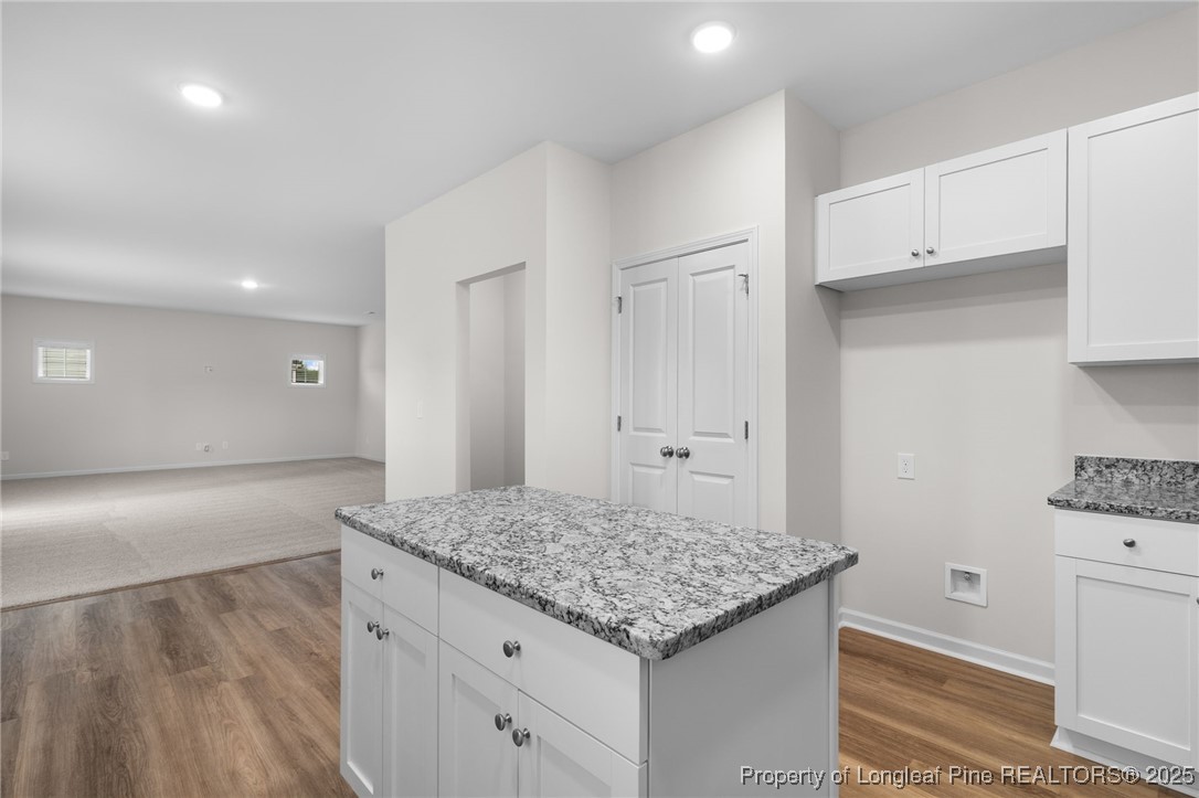 501 Traveller Way Raeford, NC 28376 - Photo 21 of 49 a kitchen with granite countertop white cabinets and refrigerator