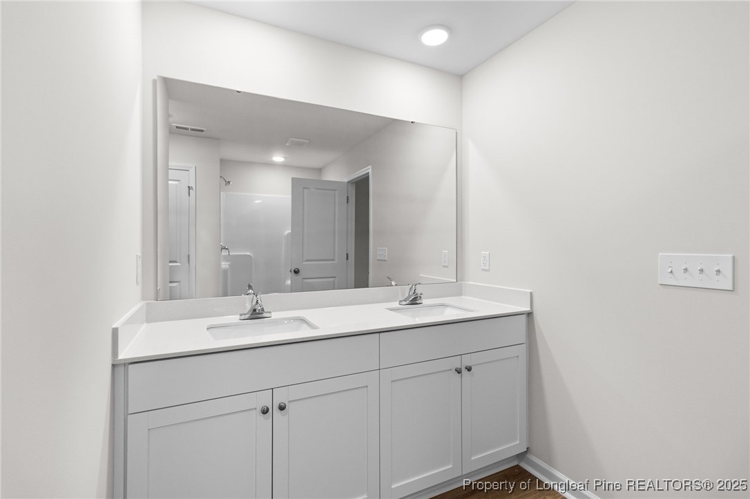 501 Traveller Way Raeford, NC 28376 - Photo 28 of 49 a bathroom with a sink and a mirror