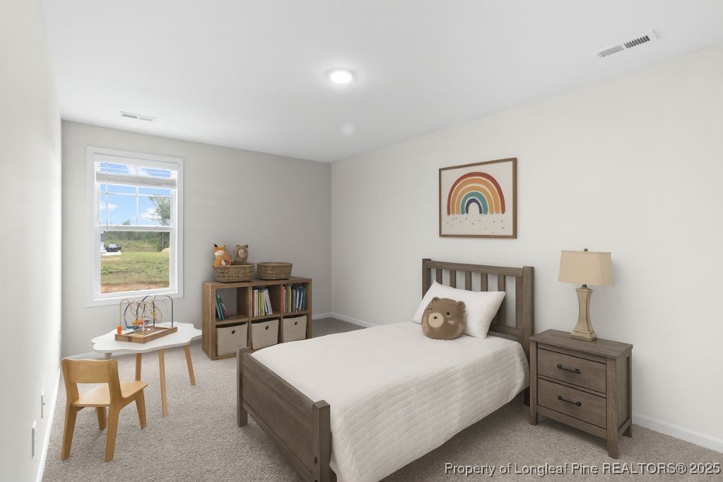 501 Traveller Way Raeford, NC 28376 - Photo 31 of 49 a bedroom with a bed and a table