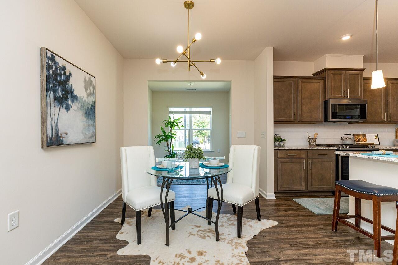 117 Lafferty Street Durham, NC 27560 - Photo 12 of 43 a view of a dining room with furniture and wooden floor