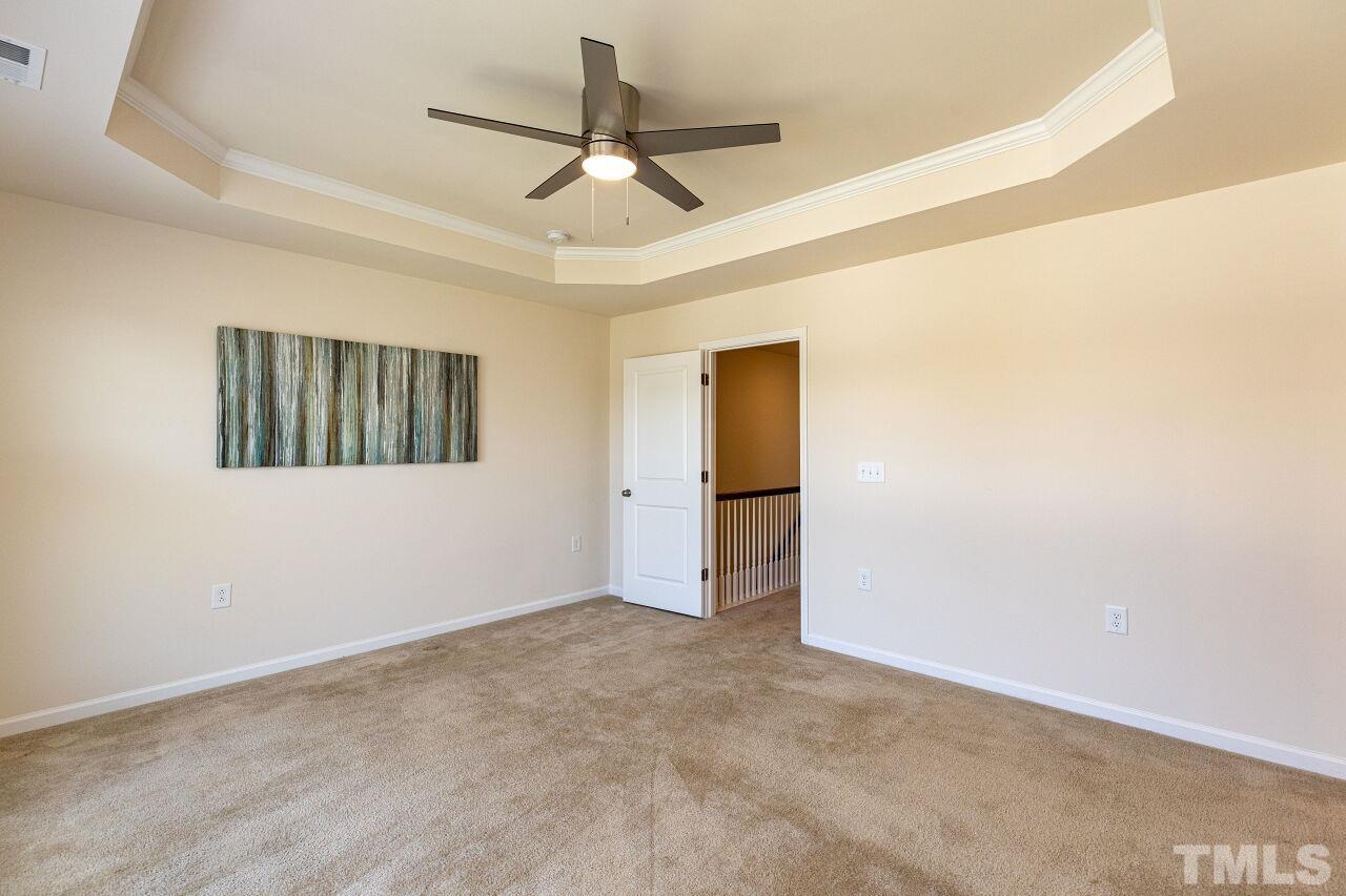 117 Lafferty Street Durham, NC 27560 - Photo 17 of 43 an empty room with a ceiling fan and a window