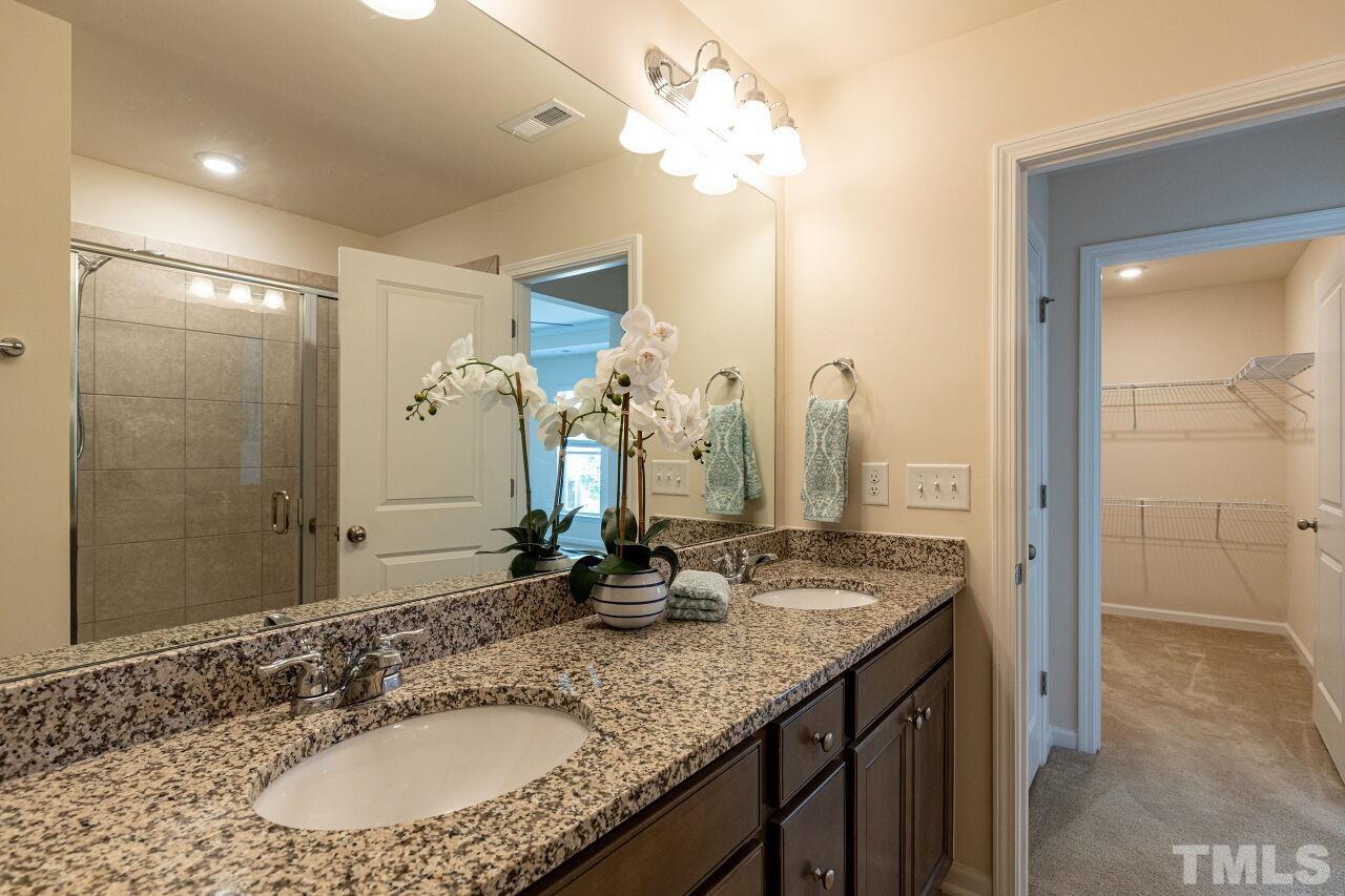117 Lafferty Street Durham, NC 27560 - Photo 19 of 43 a bathroom with a granite countertop double vanity sink and a mirror