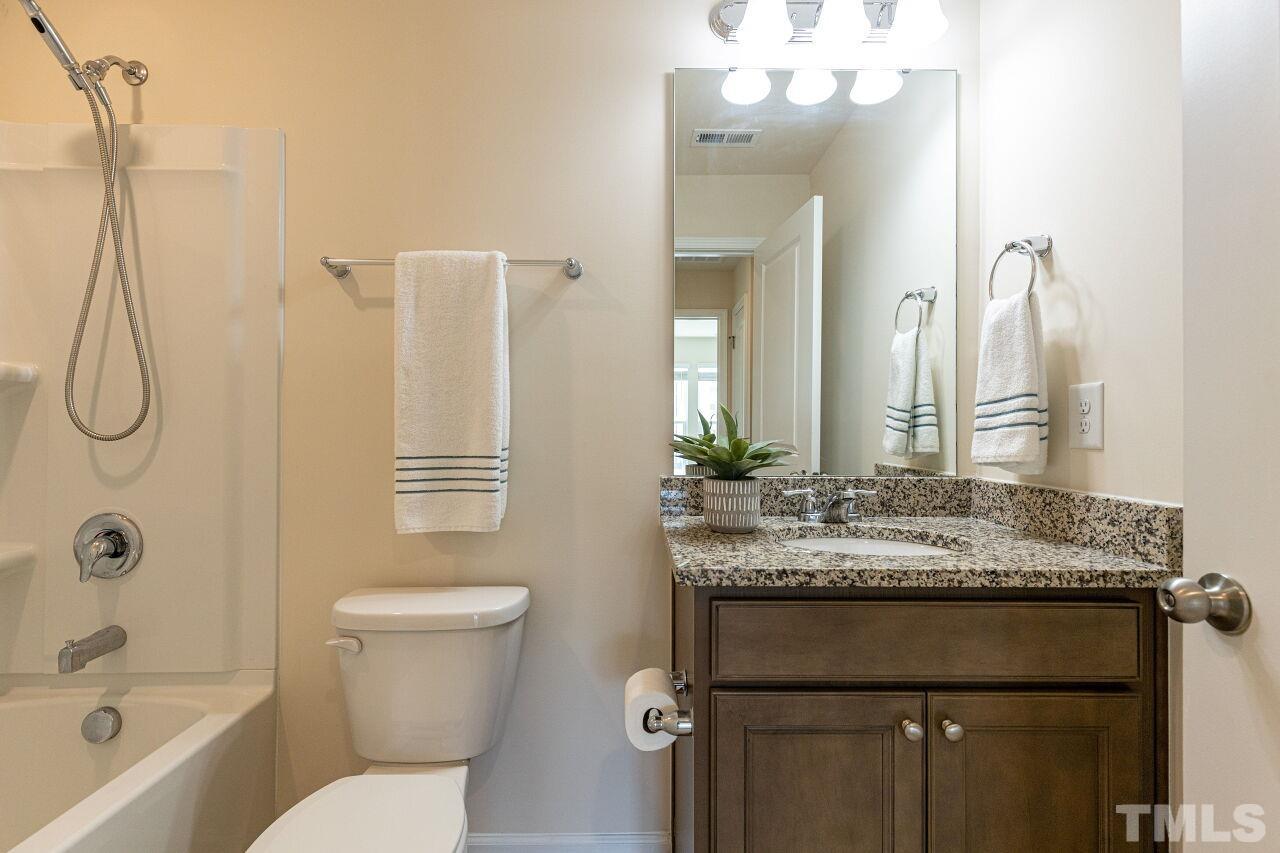 117 Lafferty Street Durham, NC 27560 - Photo 24 of 43 a bathroom with a granite countertop sink toilet and shower