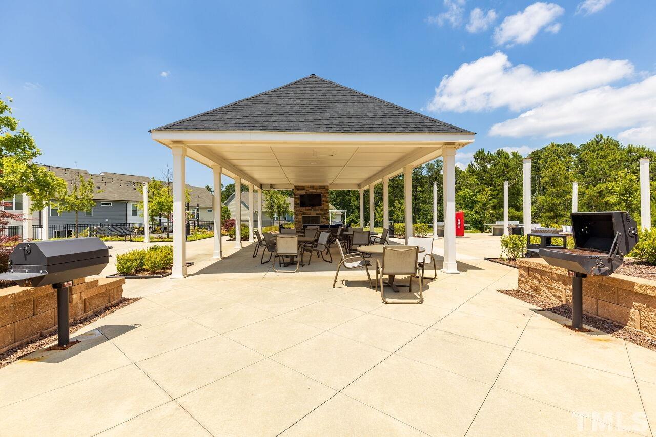 117 Lafferty Street Durham, NC 27560 - Photo 35 of 43 a view of the patio with dining table and chairs under an umbrella