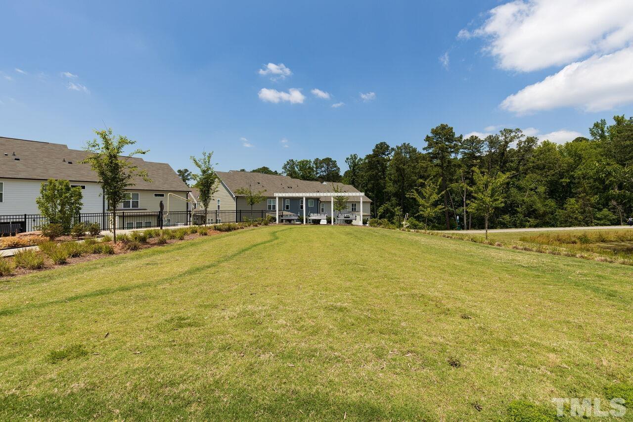 117 Lafferty Street Durham, NC 27560 - Photo 40 of 43 a swimming pool with outdoor seating and yard