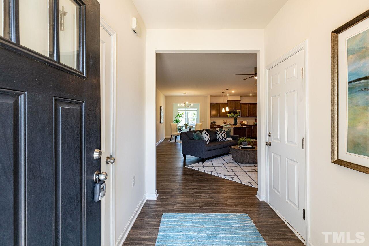 117 Lafferty Street Durham, NC 27560 - Photo 4 of 43 a view of a hallway with living room and wooden floor