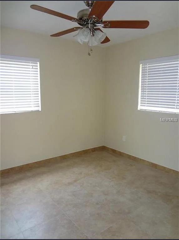 6439 Polk Street New Port Richey, FL 34653 - Photo 9 of 11 an empty room with a window and a fan