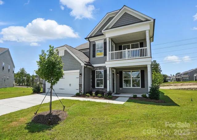 a view of a house with swimming pool and a yard