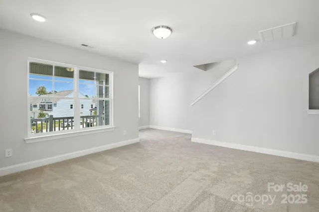 an empty room with windows and entrance