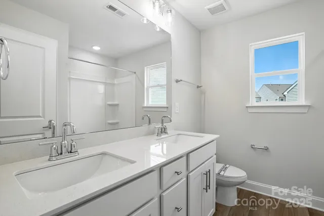 a bathroom with a sink toilet and a mirror