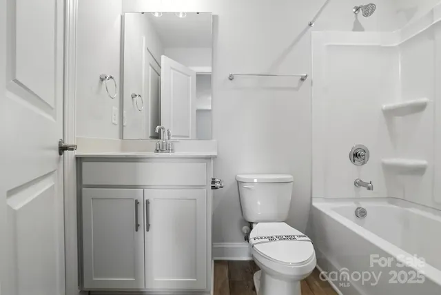 a bathroom with a sink toilet vanity and shower