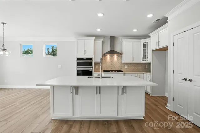 a kitchen with stainless steel appliances a refrigerator sink and cabinets