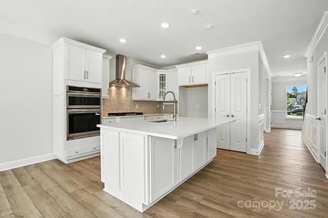 a kitchen with kitchen island granite countertop a stove and a sink