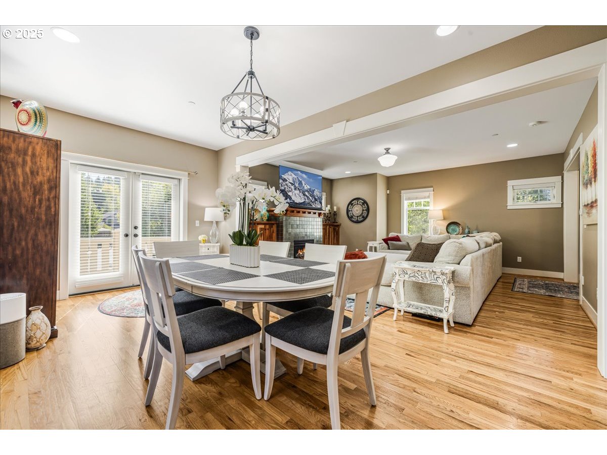 8250 Southwest Indigo Terrace Beaverton, OR 97007 - Photo 12 of 46 a view of a dining room with furniture wooden floor and chandelier