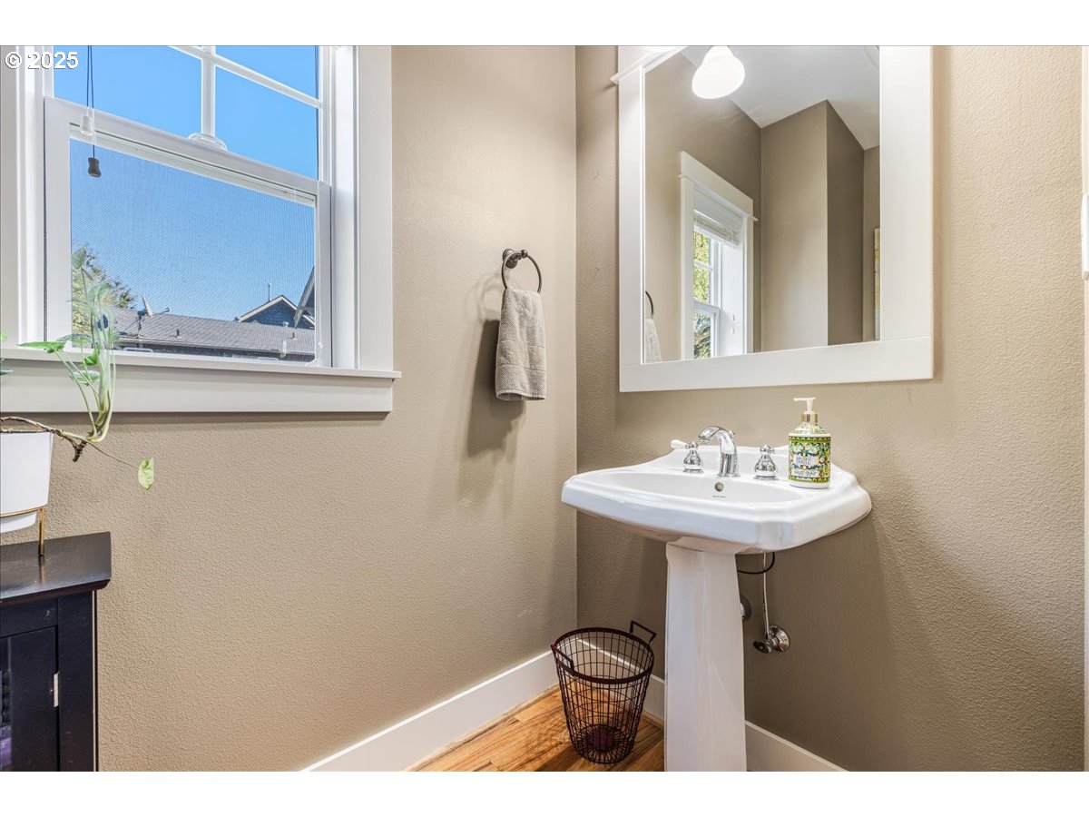 8250 Southwest Indigo Terrace Beaverton, OR 97007 - Photo 18 of 46 a bathroom with a sink a toilet and mirror