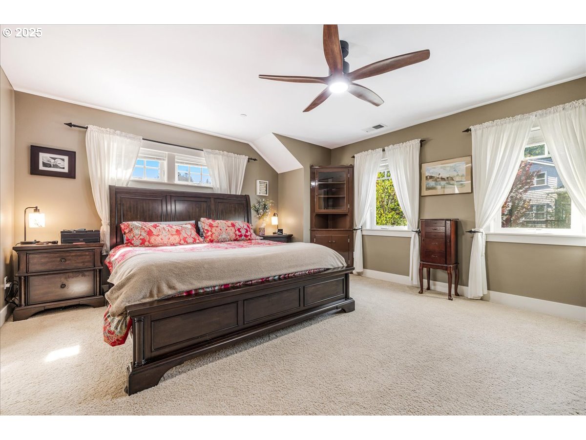 8250 Southwest Indigo Terrace Beaverton, OR 97007 - Photo 25 of 46 a spacious bedroom with a bed a window and a chandelier
