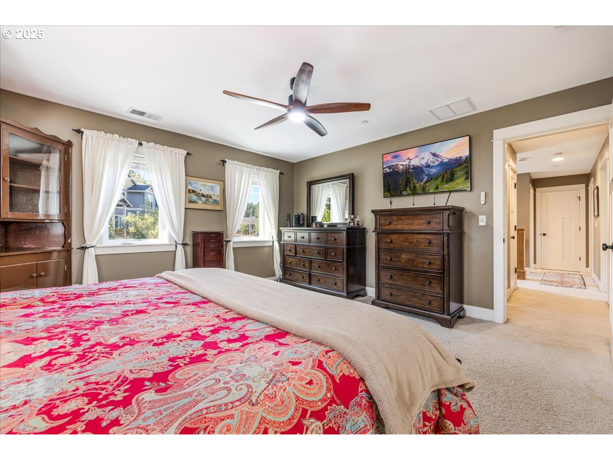 8250 Southwest Indigo Terrace Beaverton, OR 97007 - Photo 27 of 46 a bedroom with a bed and a flat screen television