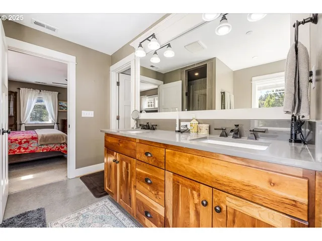 a spacious bathroom with a tub double sink and mirror