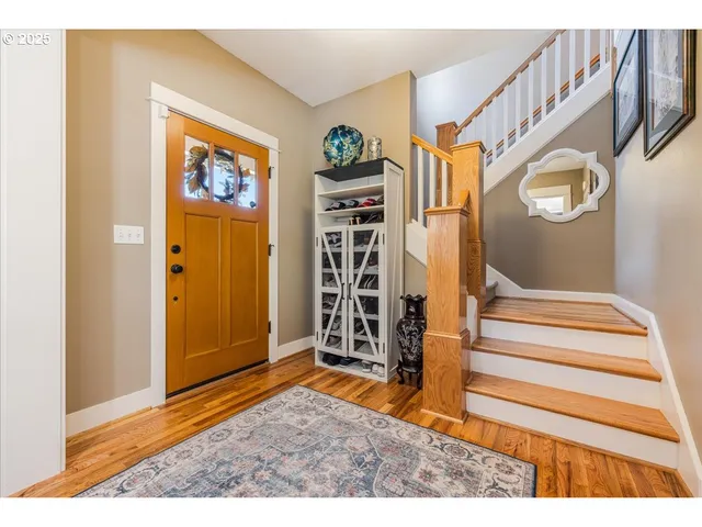 a view of an entryway with wooden floor