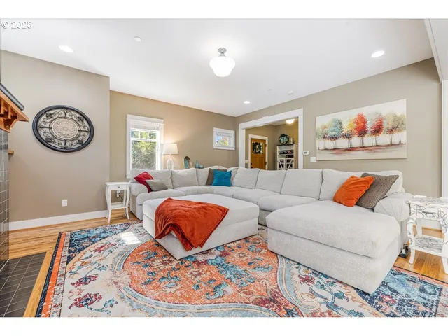 a living room with furniture a rug and a window