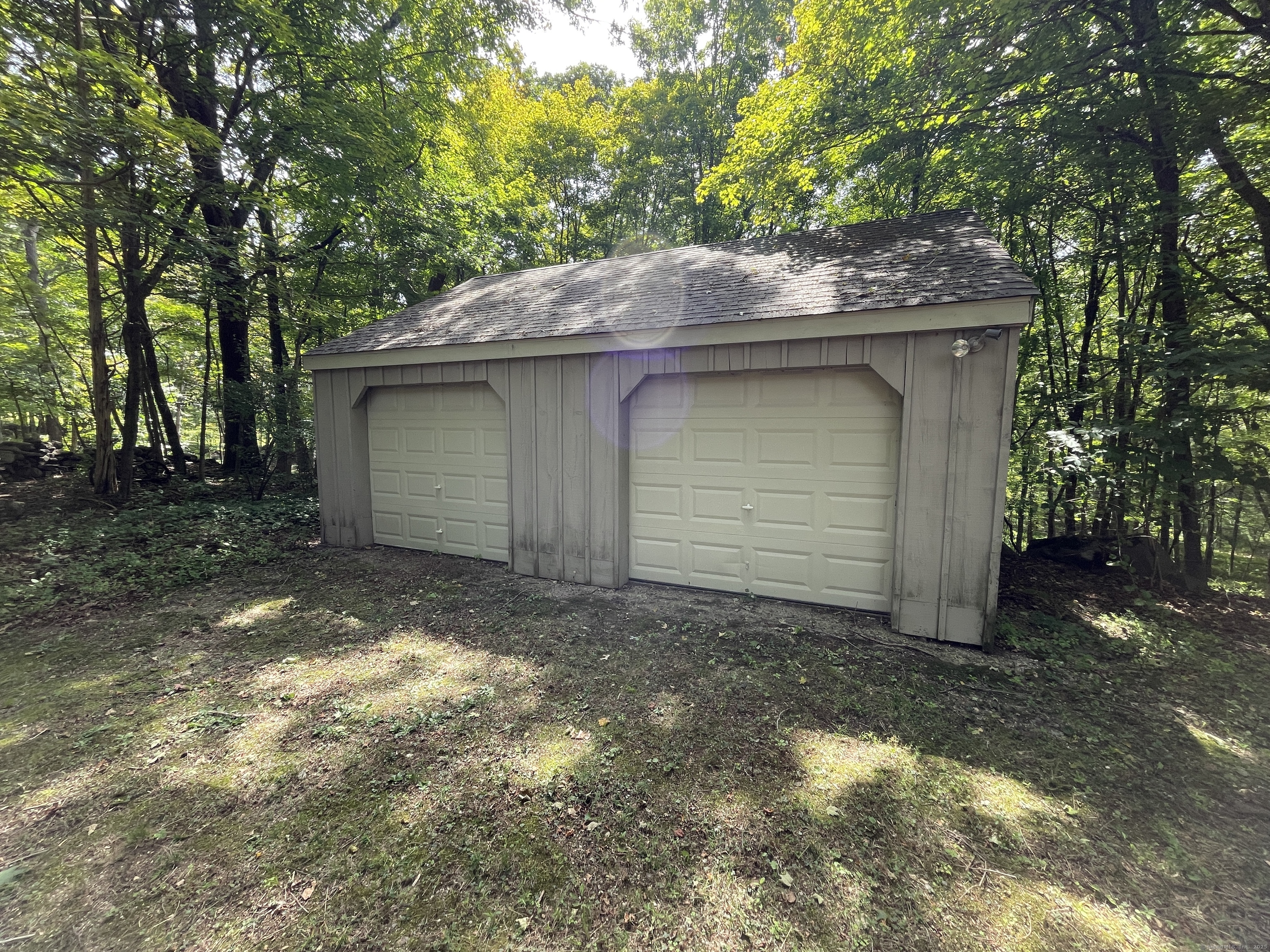 167 Baxter Road Mansfield, CT 06268 - Photo 8 of 22 a backyard of a house with garage and outdoor seating