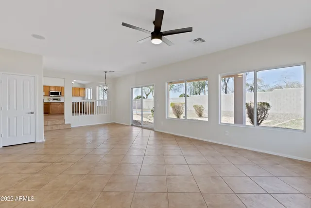 a view of a livingroom with a ceiling fan and wooden floor