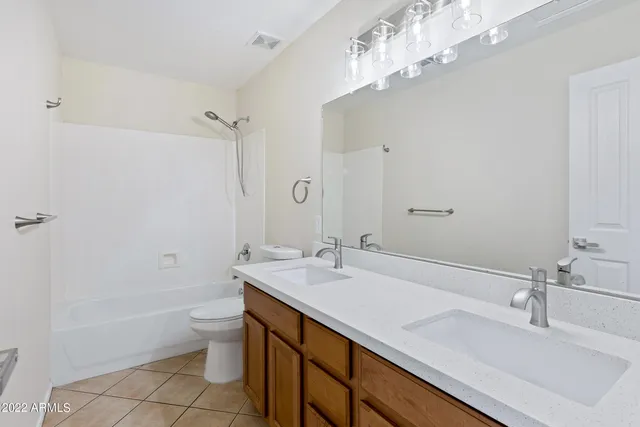 a view of a livingroom with a ceiling fan wooden floor and window