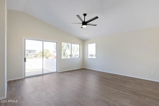 a spacious bathroom with a granite countertop sink mirror and bathtub