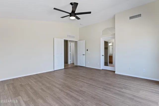 a bathroom with a granite countertop bathtub shower and toilet