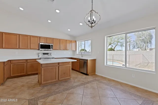 a kitchen with stainless steel appliances granite countertop a stove refrigerator sink and cabinets