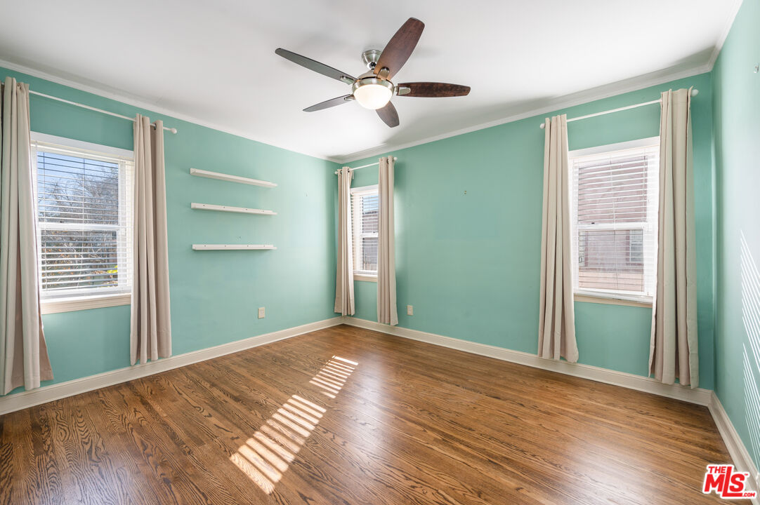 318 East Fairview Boulevard Inglewood, CA 90302 - Photo 14 of 45 a view of empty room with wooden floor and fan