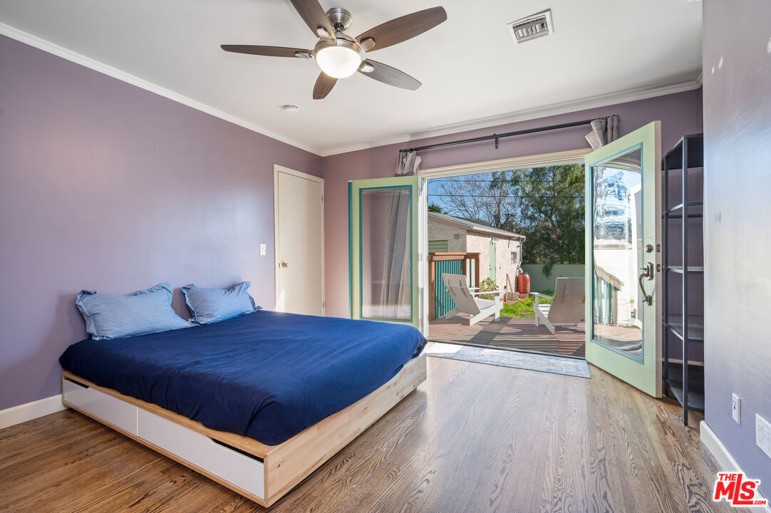 318 East Fairview Boulevard Inglewood, CA 90302 - Photo 19 of 45 a bedroom with a large bed and a chandelier