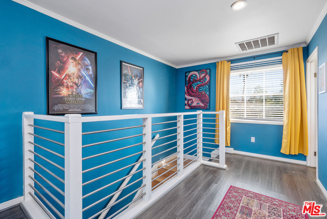 318 East Fairview Boulevard Inglewood, CA 90302 - Photo 22 of 45 a view of a bedroom with wooden floor and a window