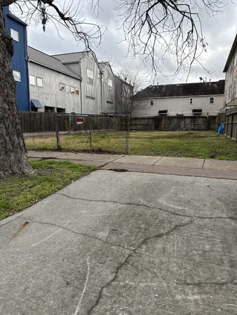 a view of a big house with a big yard and large trees