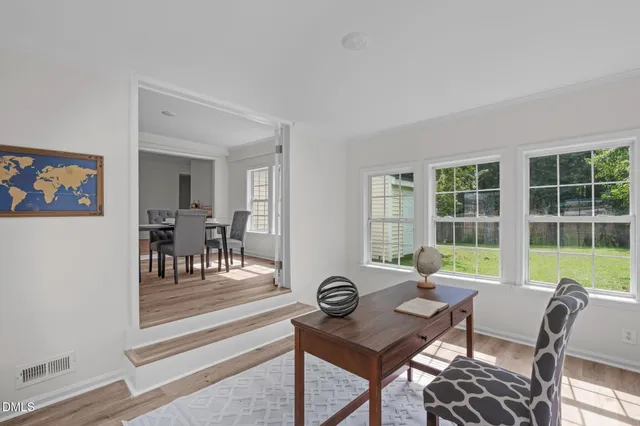 a view of a dining room with furniture and wooden floor