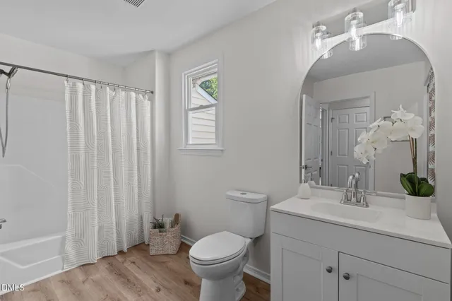 a bedroom with a bed and painting on the wall