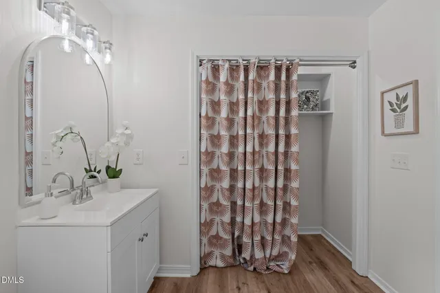 a bathroom with a granite countertop toilet a sink and a mirror