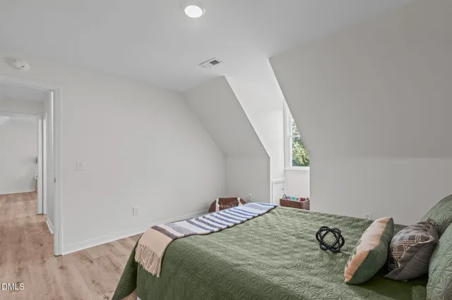 a bedroom with a bed and a mirror