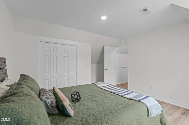 a bedroom with a bed and white walls