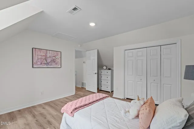 a bedroom with bed and a window