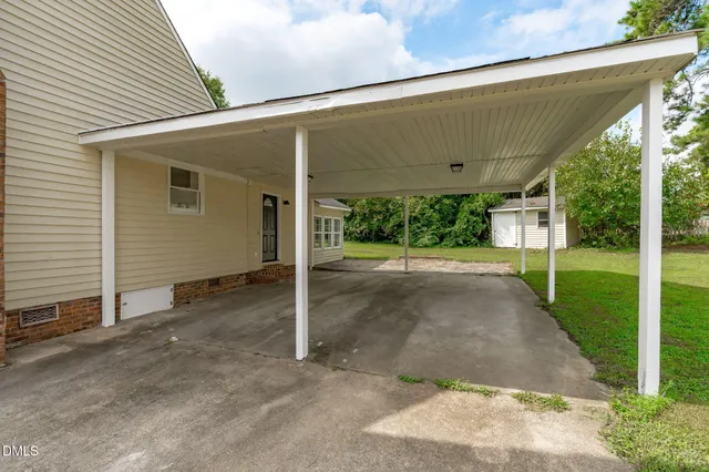 a view of a house with a yard and sitting area