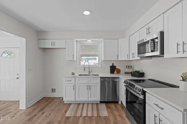 a kitchen with granite countertop cabinets a dining table and chairs