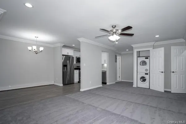 a view of an empty room with a ceiling fan