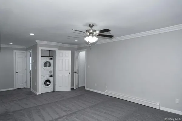 an empty room with windows and closet