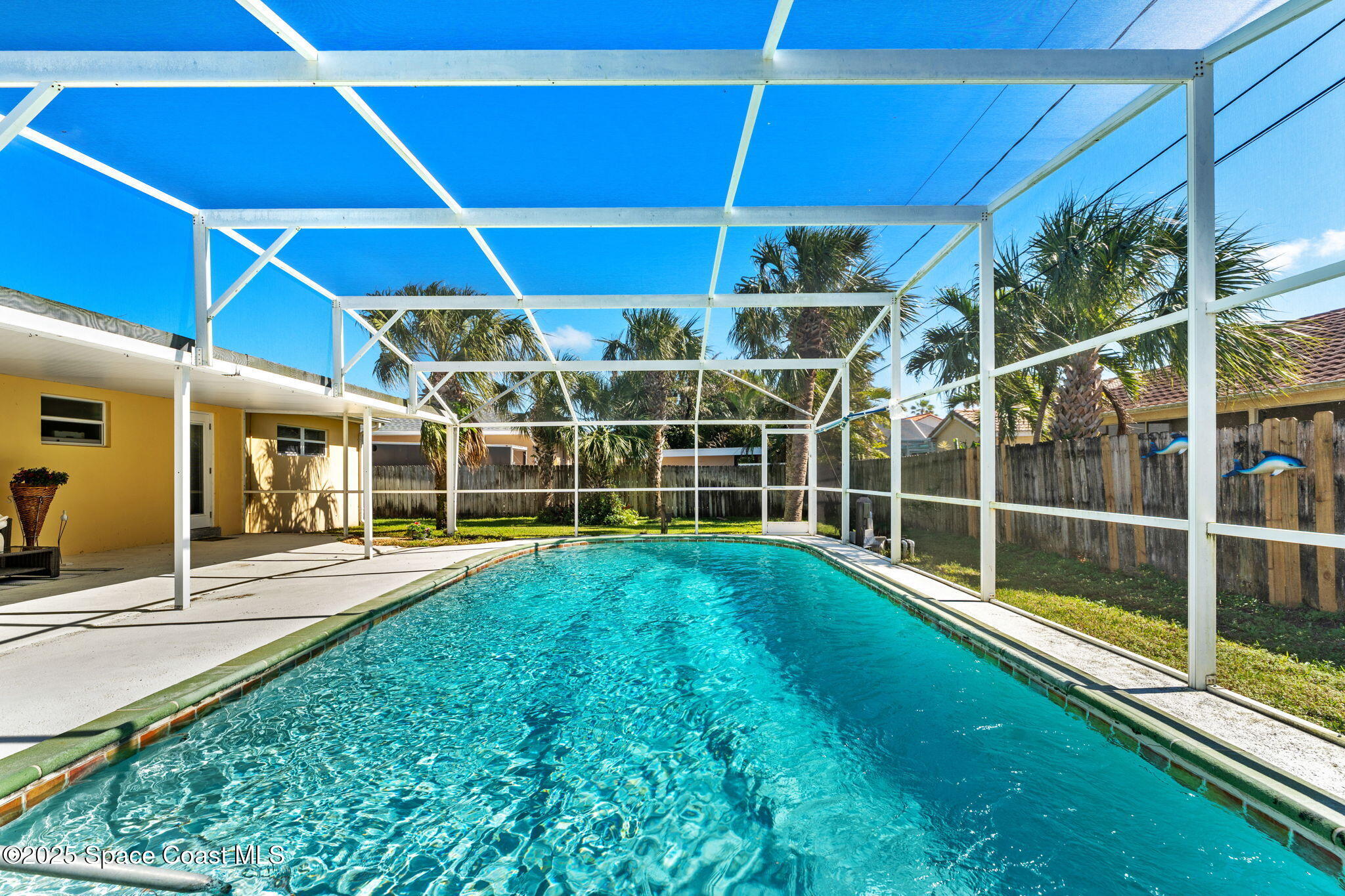 141 Diane Circle Indialantic, FL 32903 - Photo 11 of 36 a view of a backyard with table and chairs under an umbrella