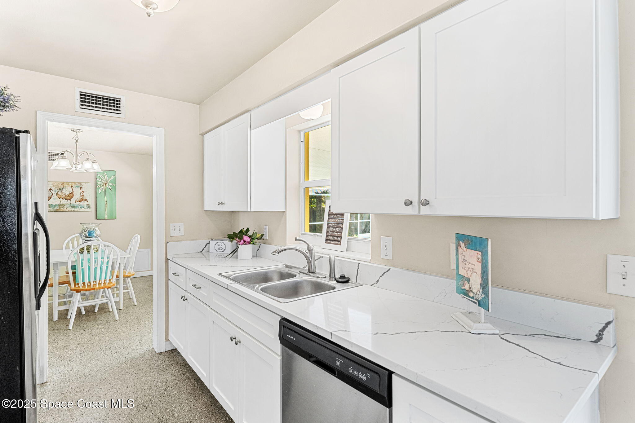 141 Diane Circle Indialantic, FL 32903 - Photo 13 of 36 a kitchen with a sink cabinets and window
